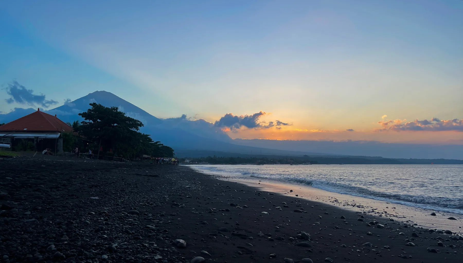 Amed beach at sunset with mount agung on the background