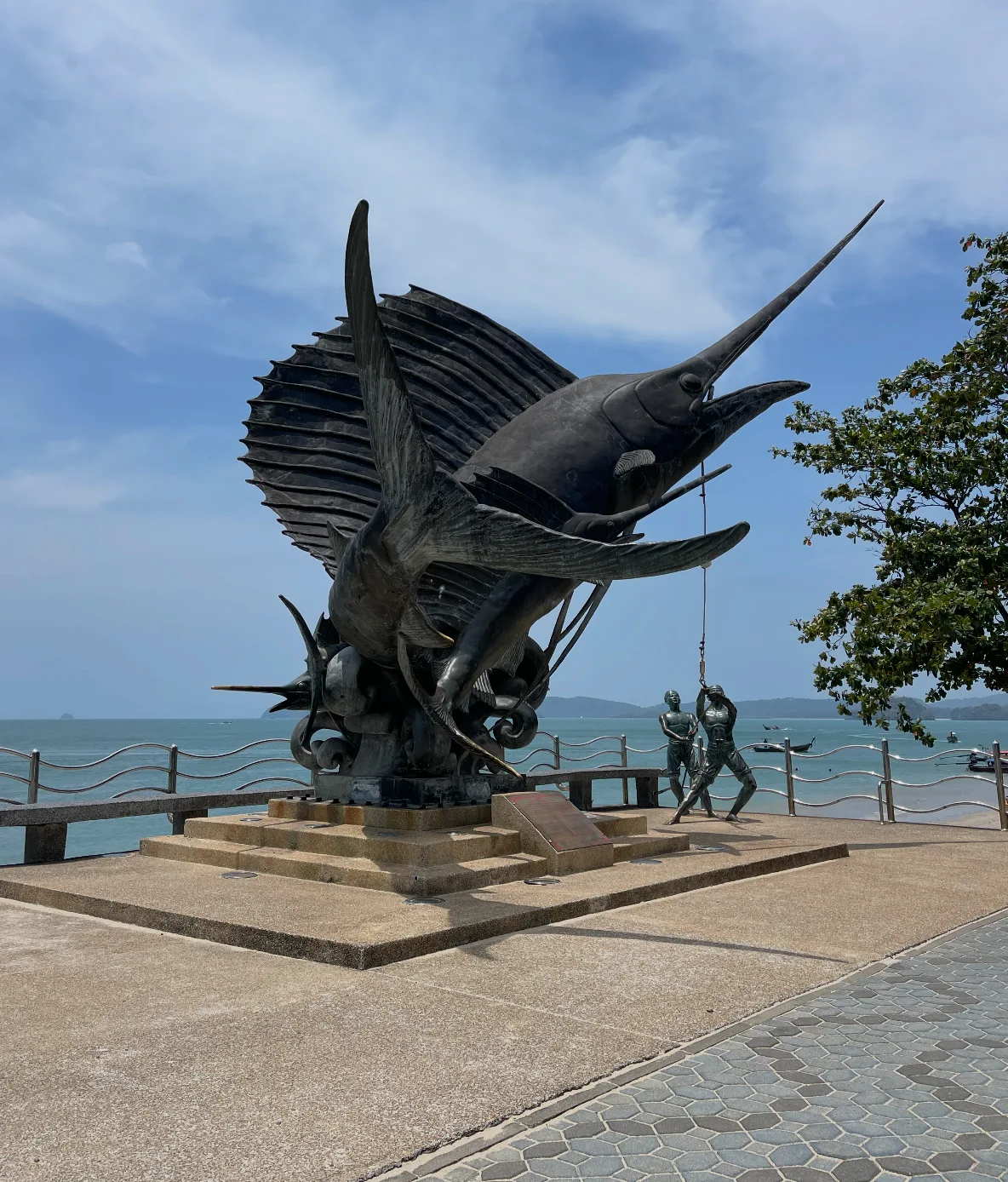 sculpture of fish and fisherman in ao nang, thailand