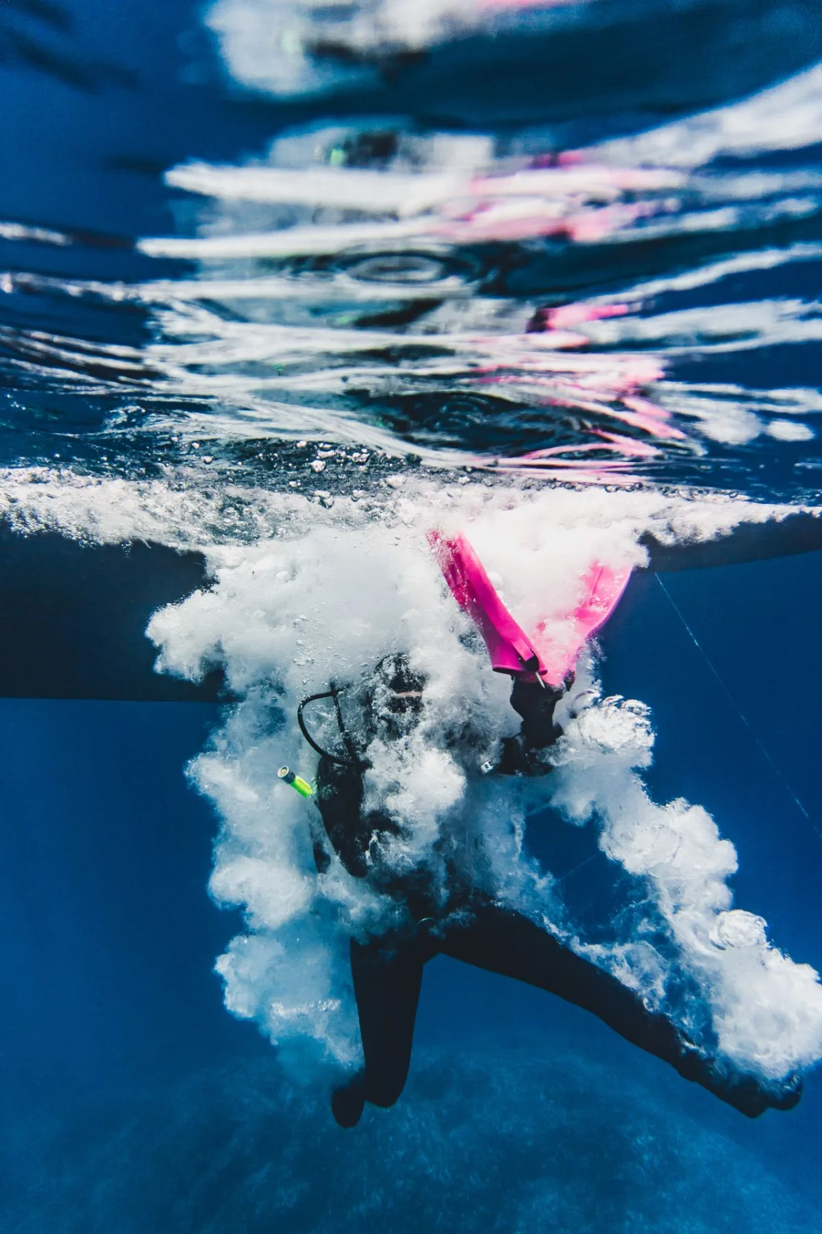 scuba diver doing a giant stride jump from a boat into the sea