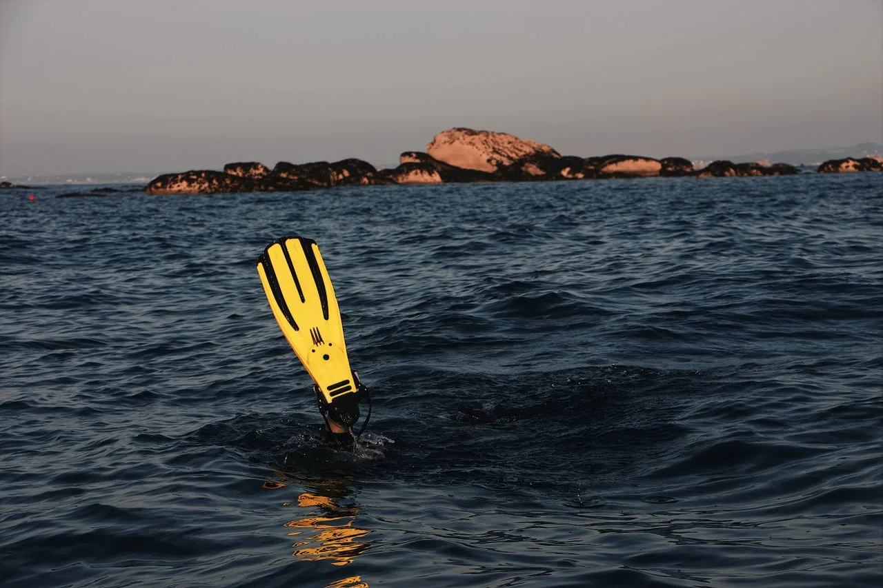 yellow scuba fin in the ocean