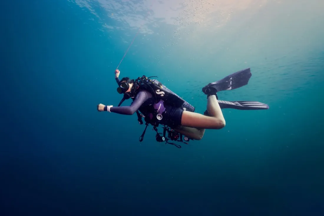 Caro Santamaria floating in open water in scuba gear