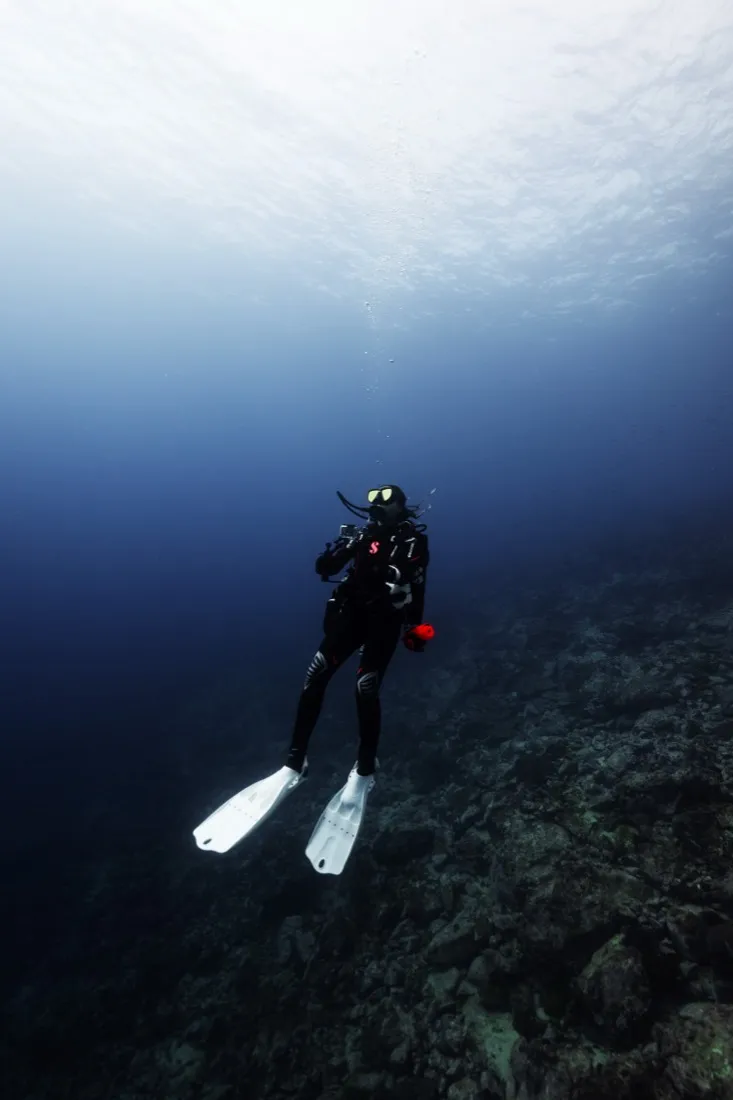 Caro Santamaria scuba diving in blue water