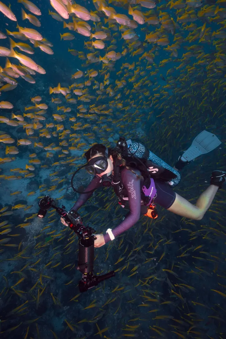Caro Santamaria scuba diving among reef fish