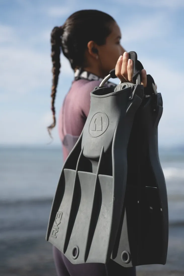 Apeks scuba diving fins held on the beach